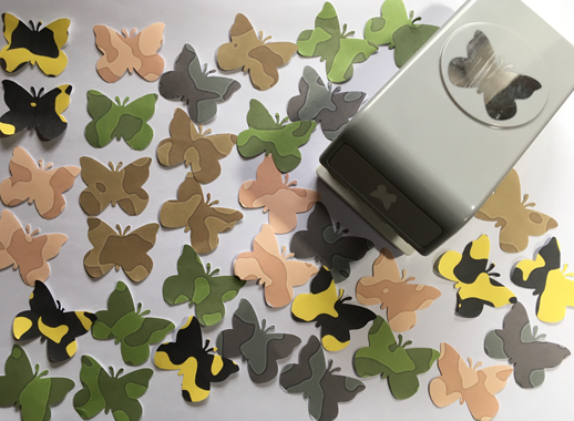 Image of paper punched butterflies with varying colouration and textures.